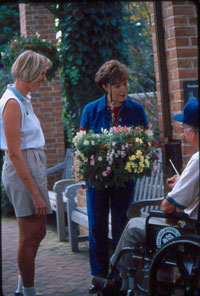 Women and man with flowers