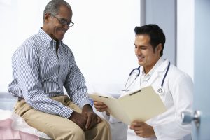 Male doctor talking with male patient