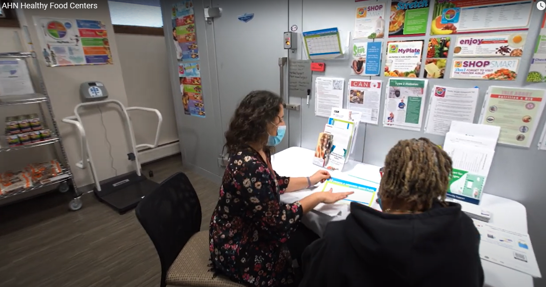 Image of two people reviewing a paper at a desk.