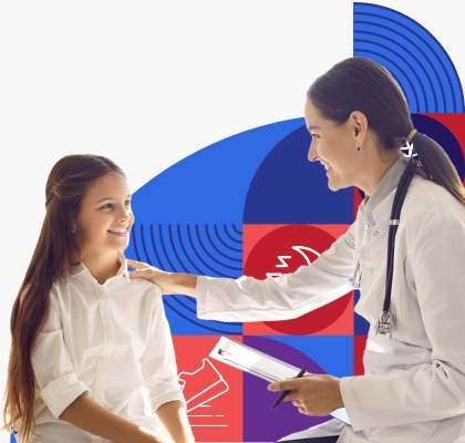 A smiling provider in a white coat speaks with a young female patient and places her hand on the girl's shoulder.