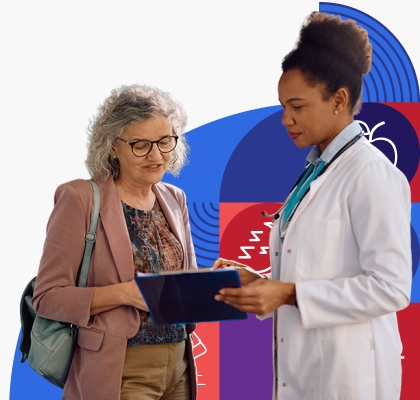 An older woman goes over information on a clip board with a young, female provider with brown skin and dark curly hair.