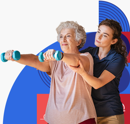 An older woman lifts dumbbells while a health care provider supports her arms.