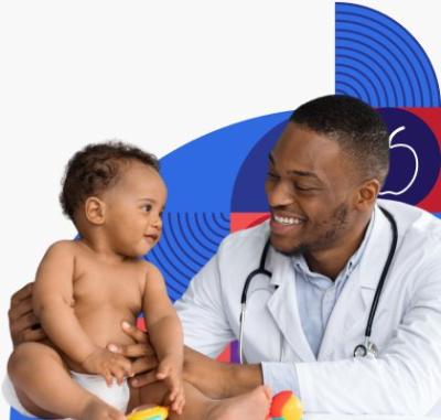 A smiling doctor helps a healthy baby sit up for an exam.