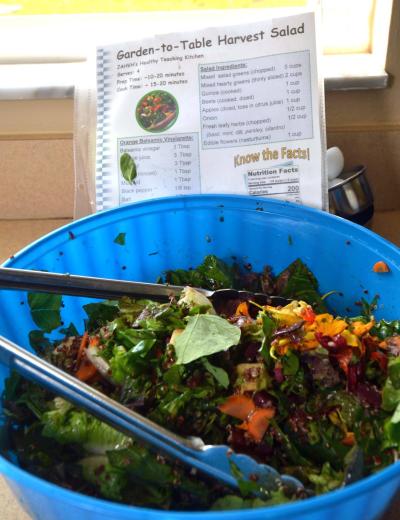 Image of a salad bowl with a recipe sheet behind it