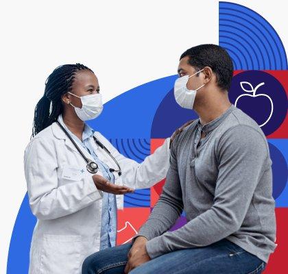 A doctor is wearing a face mask and putting their hand on a masked patient who they are having a conversation with. 