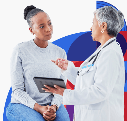 A young Black woman speaks with a female provider.
