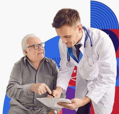 An older white man goes over information on a clip board with a young male provider wearing a white lab coat.