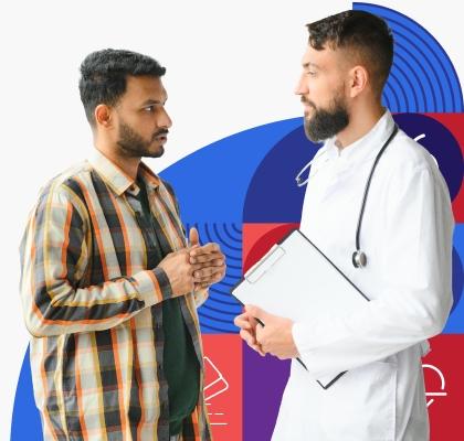 A young man with brown skin and short dark hair speaks with a male provider wearing a white lab coat.