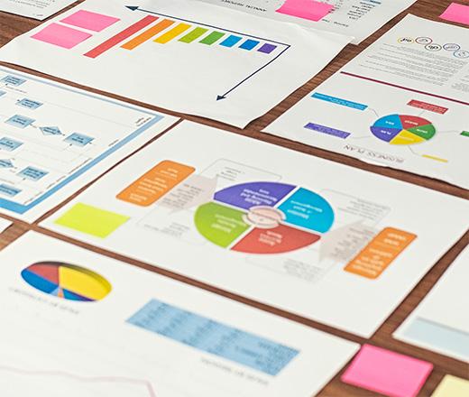 Papers with colorful charts and graphs.