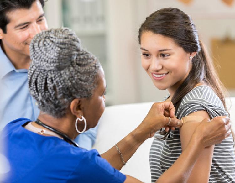 Woman receiving vaccine from a provider.