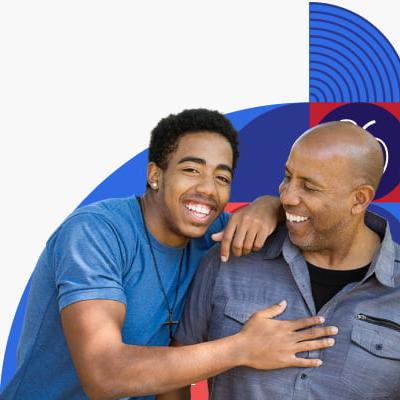 Father and teen son laughing together.