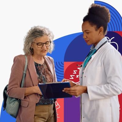 An older woman goes over information on a clip board with a young, female provider with brown skin and dark curly hair.