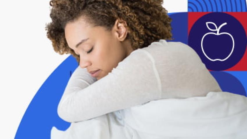 A woman laying down and sleeping in her bed.