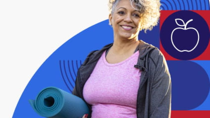 A woman holding a yoga mat.