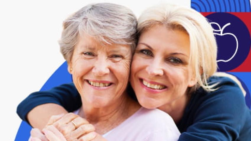 Two women hugging and smiling.