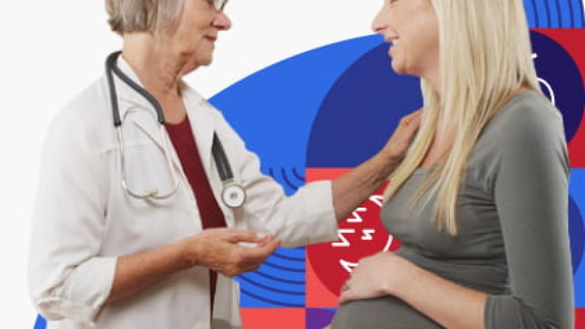 Pregnant woman talking with health care provider.