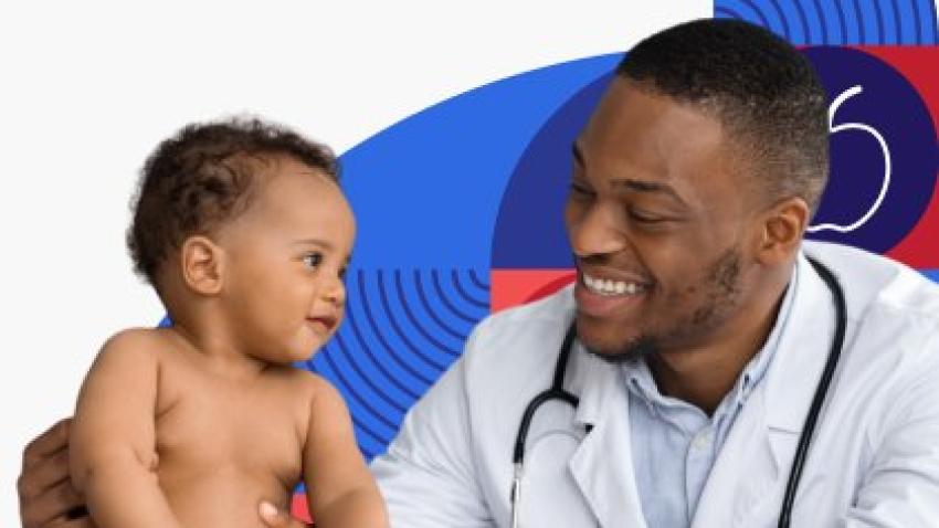A smiling doctor helps a healthy baby sit up for an exam.