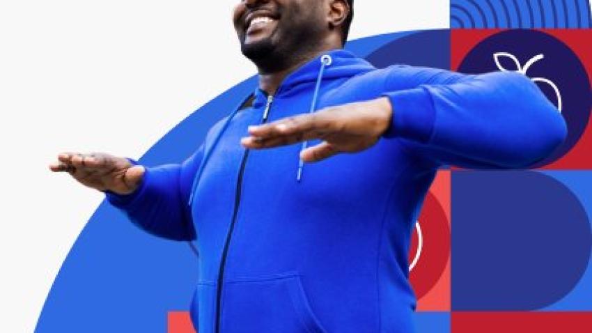 A man in a blue hoodie exercising.